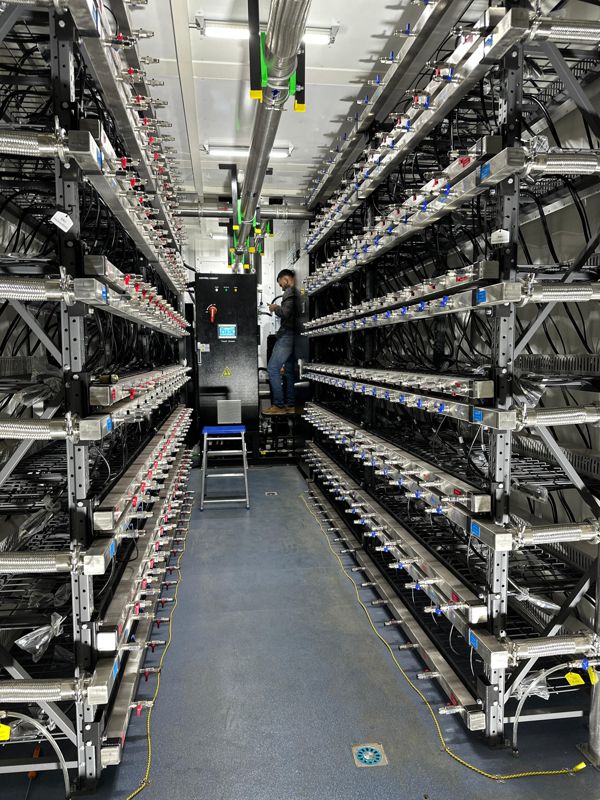 Inside: hydro racks, coolant manifolds and the control cabinet. Every machine on its own valve.